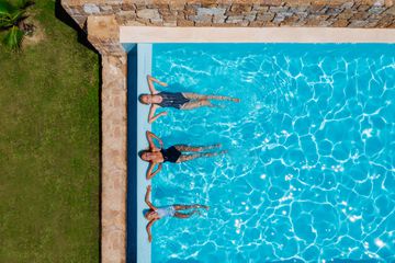 Two women and a child relax in a pool