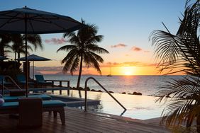 View of the sunset over the pool at Curtain Bluff hotel in Antigua 