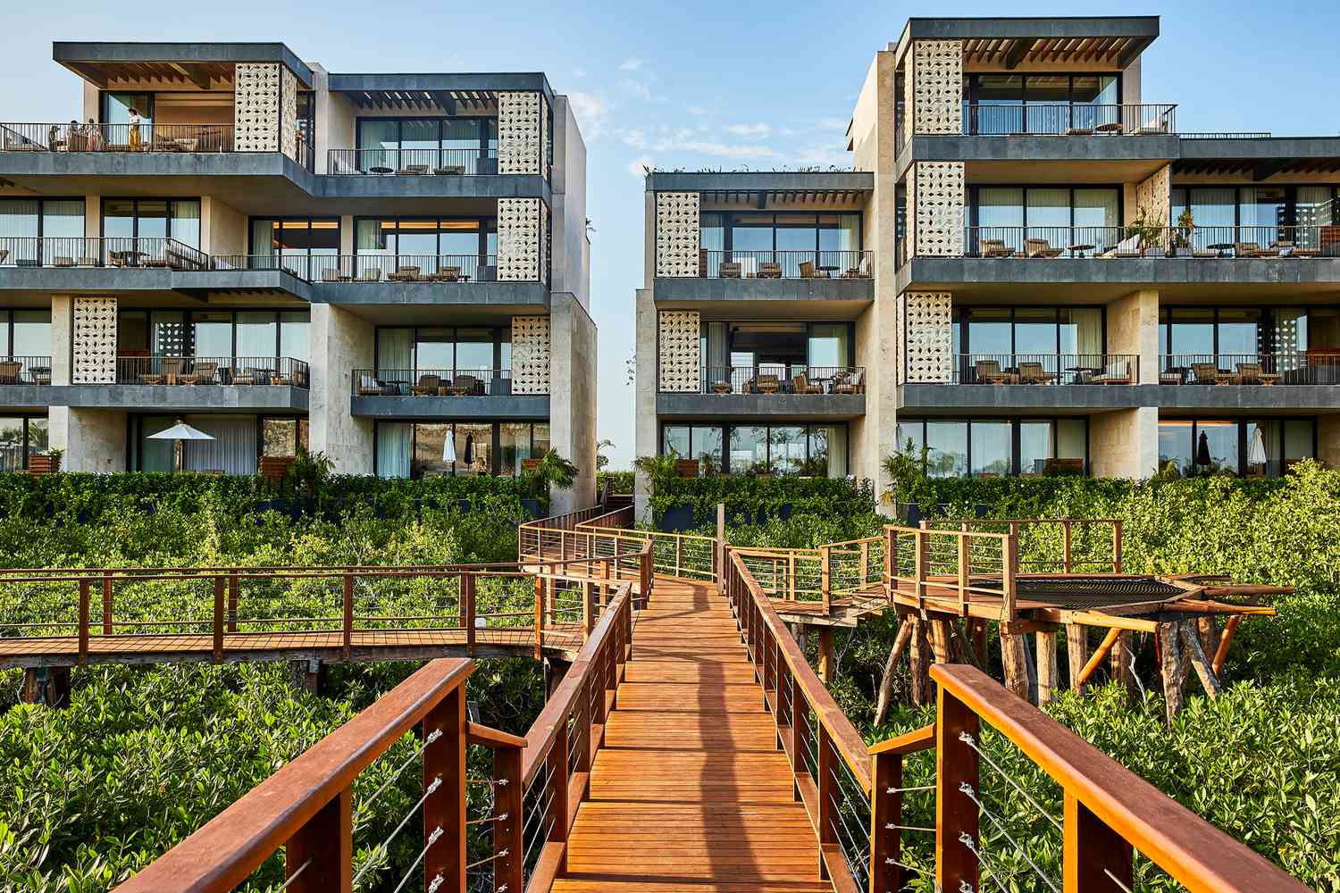 Exterior of the Etereo hotel, seen from a wooden walkway