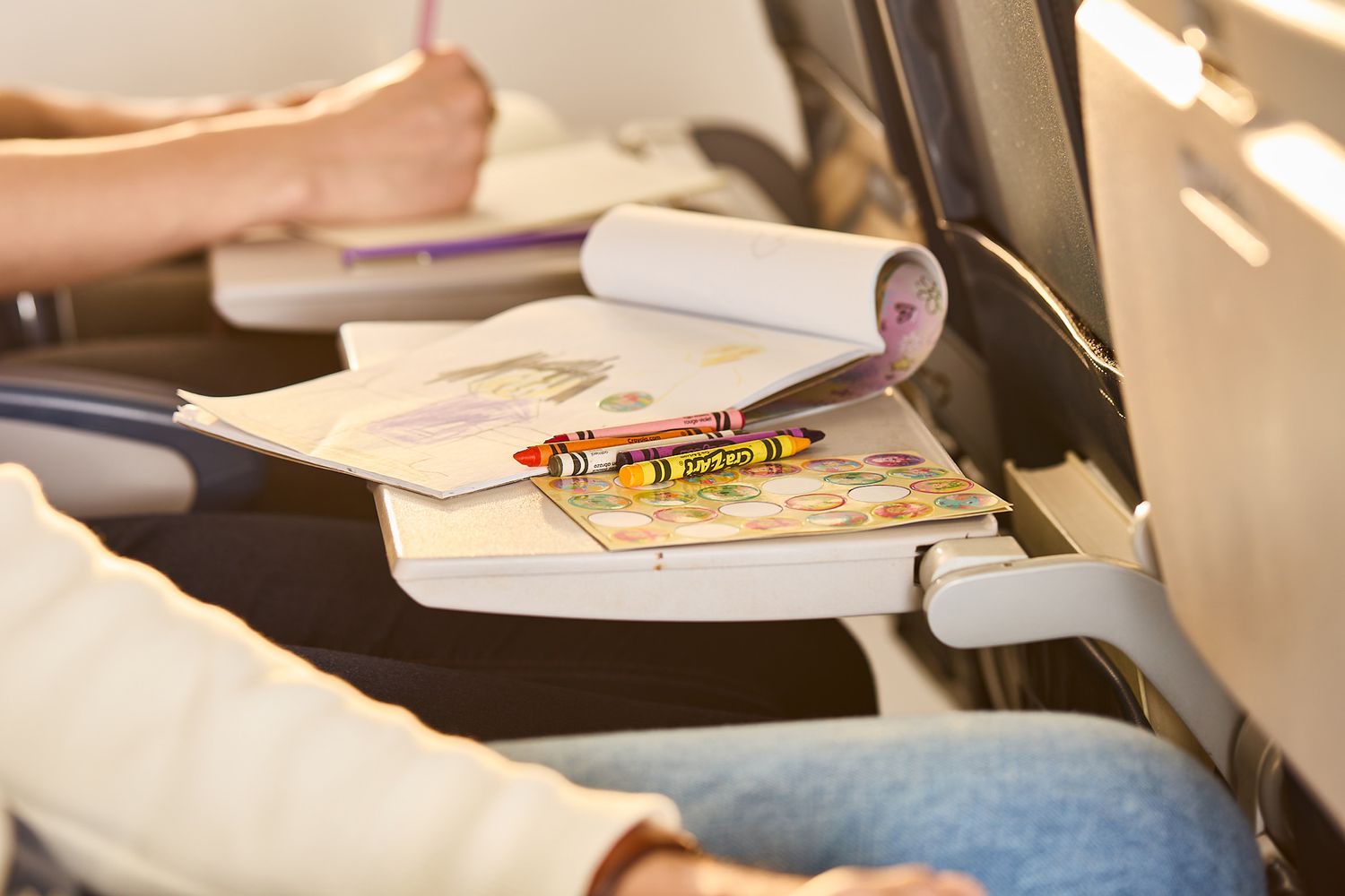 Kids drawing with crayons on a plane