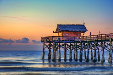 Moon rising over the ocean at the Cocoa Beach Pier in Bevard County, Florida. HDR i mage tone mapped in Photomatix Pro and enhanced with Topaz software.