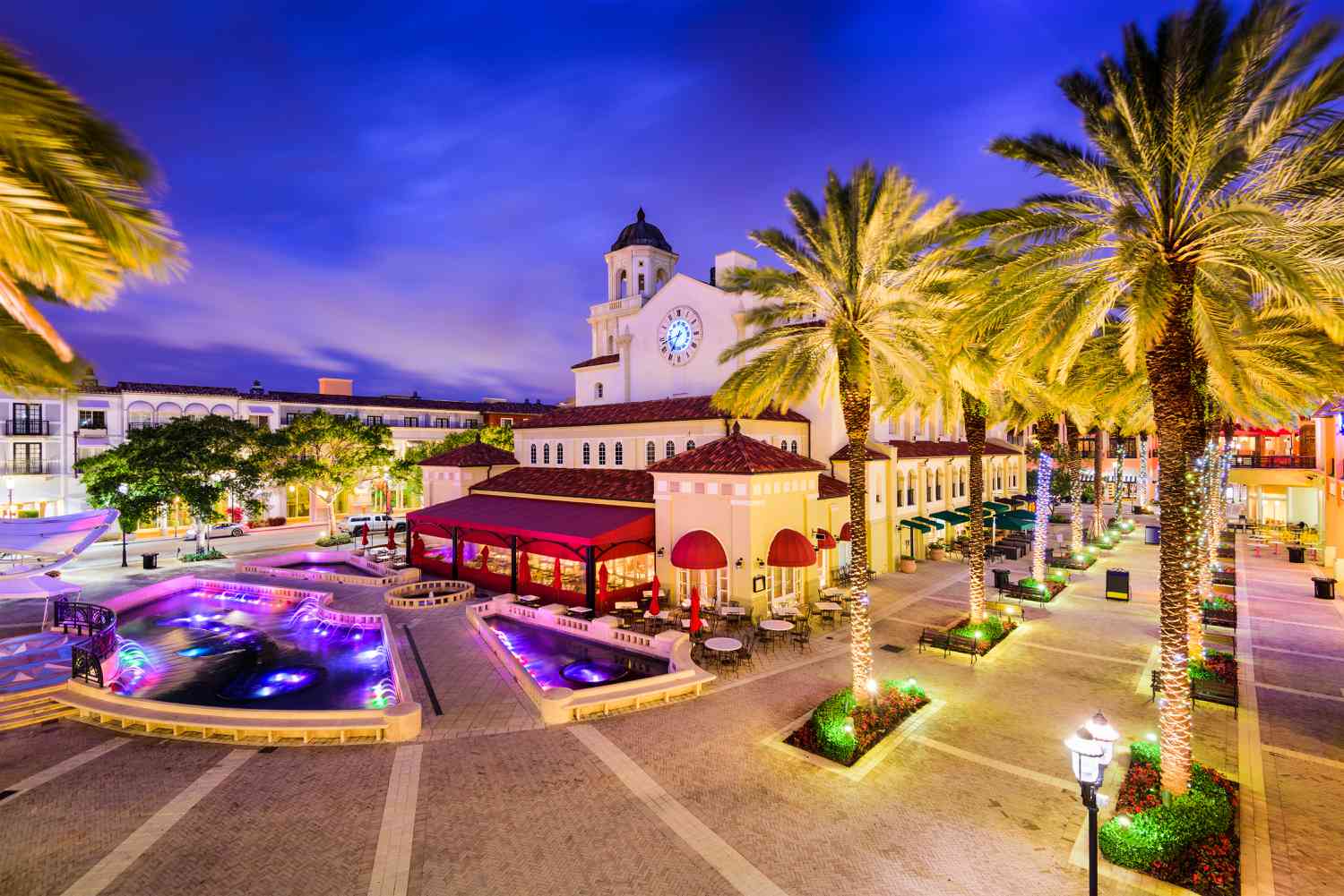 Evening view of plaza with palm trees and fountains at CityPlace in West Palm Beach, Florida