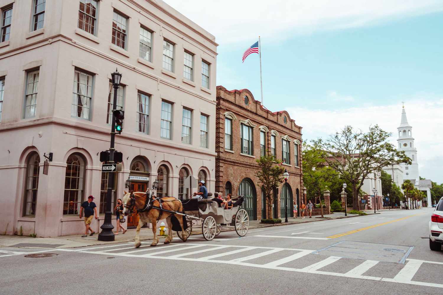 A horse drawn carriage going down broad street in Charleston
