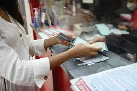 Woman handing over her passport at passport control