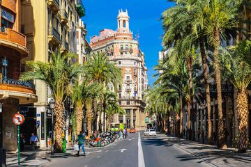 Carrer de les Barques street with palm trees on a sunny day in Valencia, Spain