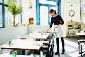 Waitress setting table in a restaurant