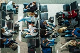 Overhead view of people waiting in seats in an airport terminal