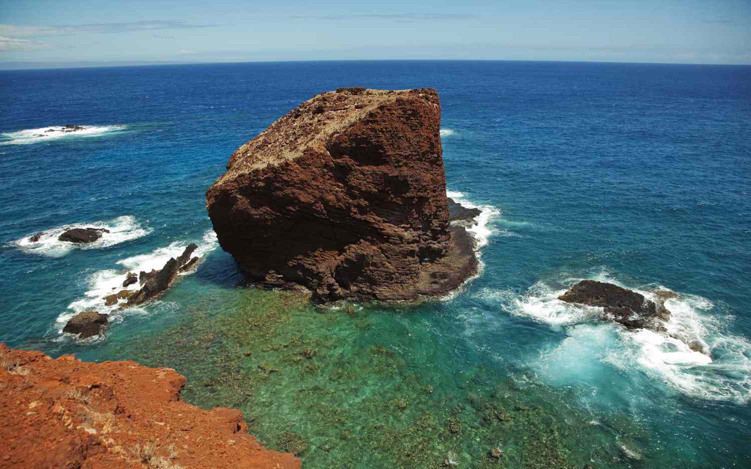 Pu'upehe, or Sweetheart Rock, stands in the waves off the coast of Lanai, Hawaii.