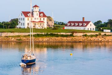 Yacht anchored near Coast Guard station at Block Island, Rhode Island, USA, shortly after sunrise