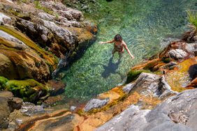A person takes a dip in the hot springs at Castle Hot Springs in Arizona