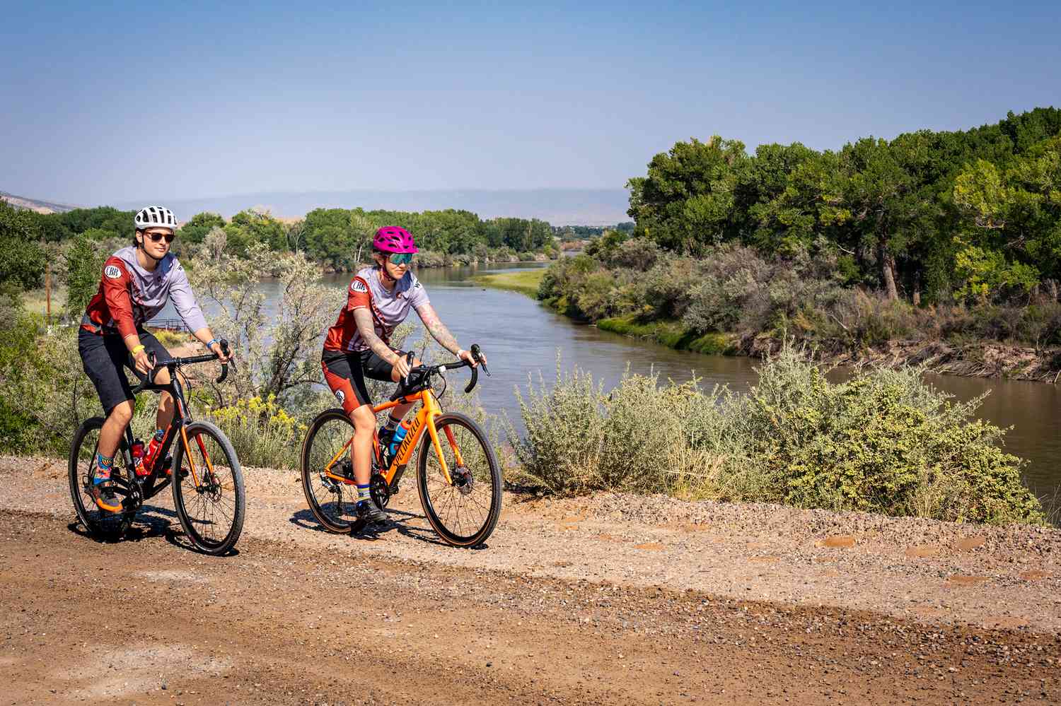 Two people mountain biking on a trail