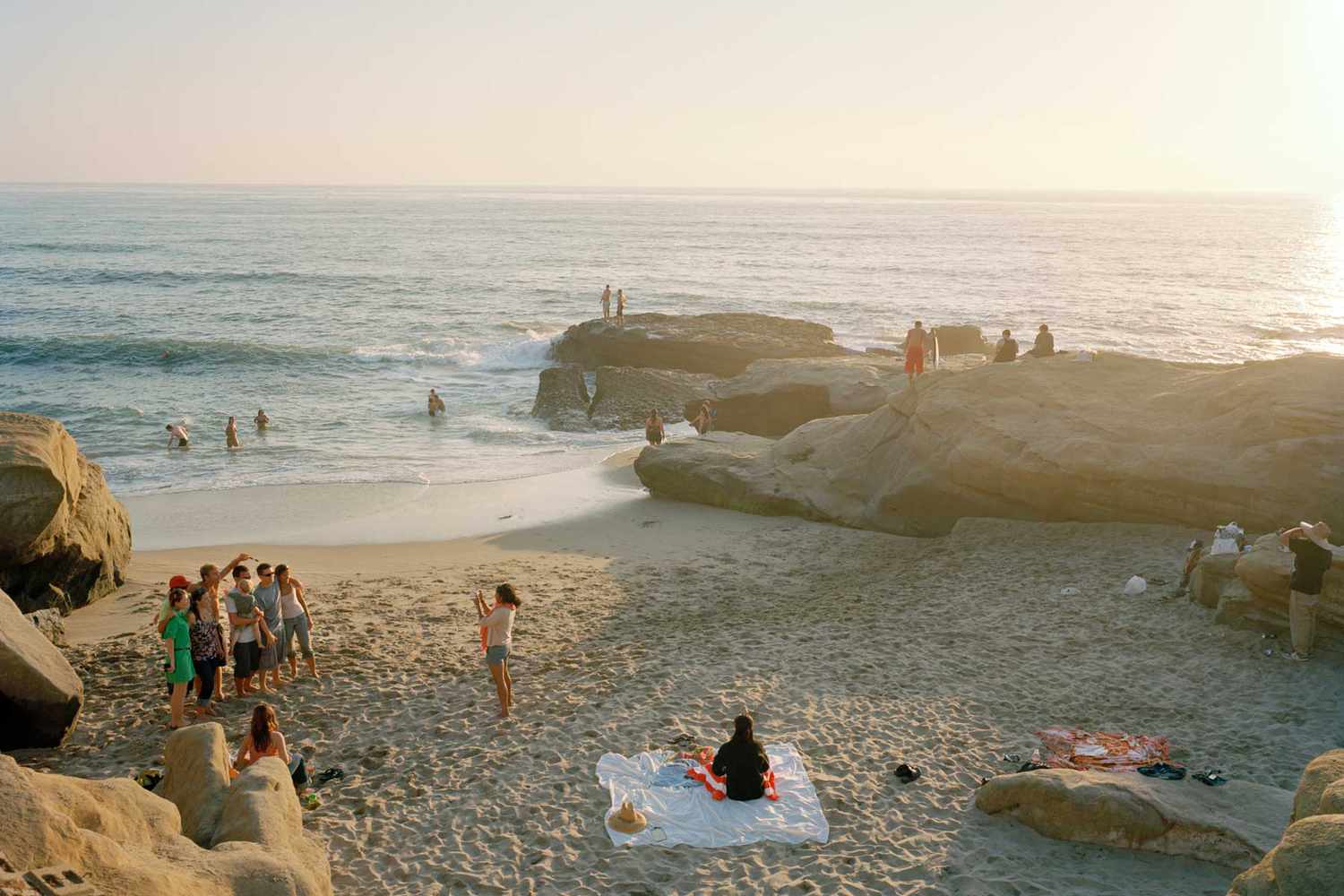 People on the sand and in the water at Ocean Beach, San Diego, California