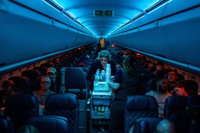 Flight attendants serve refreshments on a Delta Airlines flight from Hartsfield-Jackson International Airport
