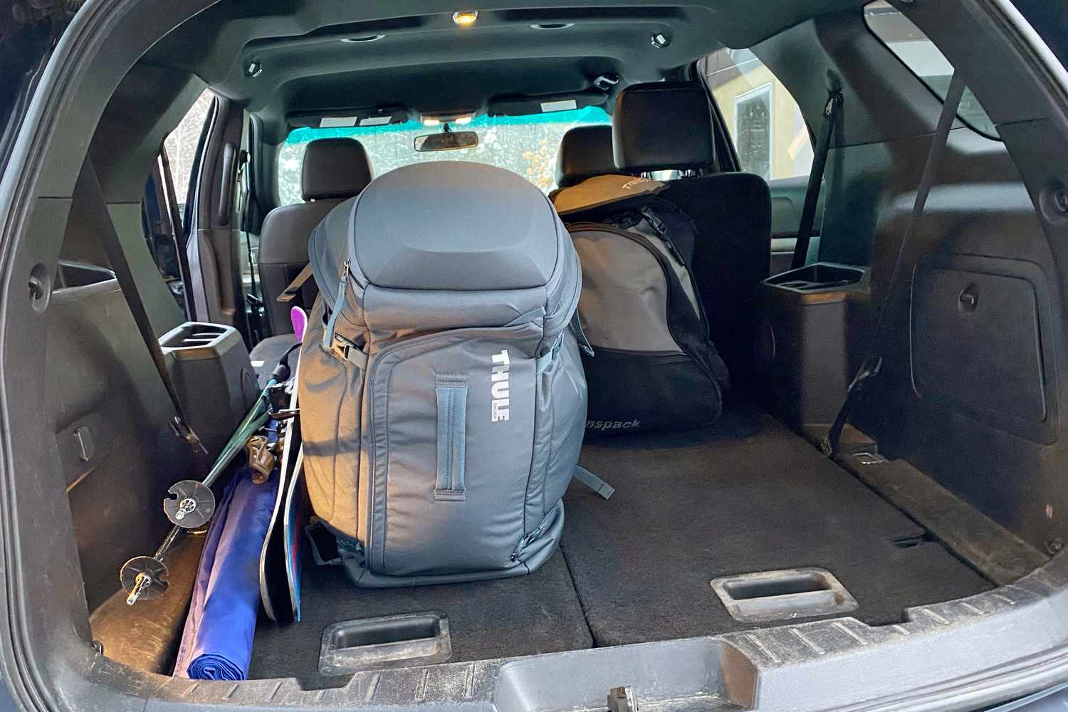 The Thule Roundtrip 60L sitting in a car trunk