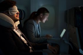 A man sleeping on airplane