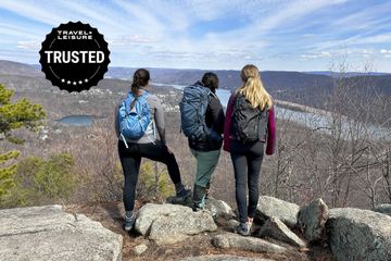 Three women on a mountain with hiking backpacks