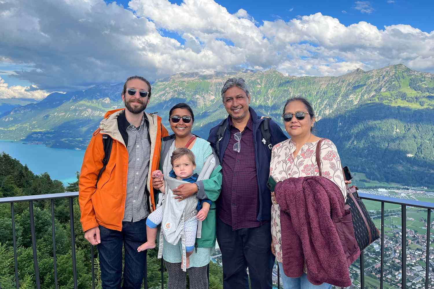 A group photo of a family atop a mountain in Switzerland 