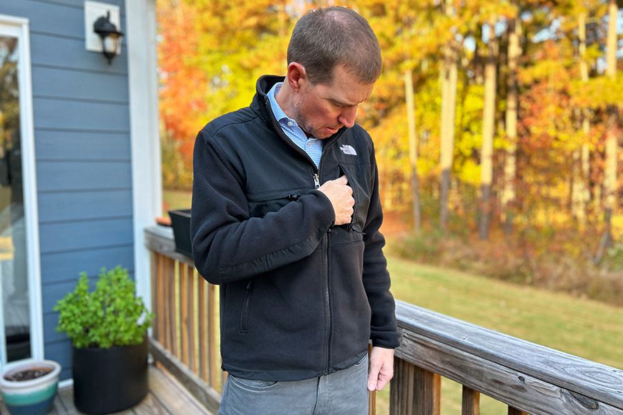 Man zipping up fleece jacket