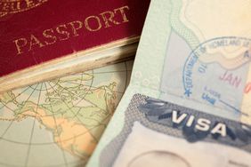 Close up of edges of a passport and a map in the background
