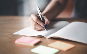 Business woman working at office with documents on his desk, Business woman holding pens and papers making notes in documents on the table, Hands of financial manager taking notes