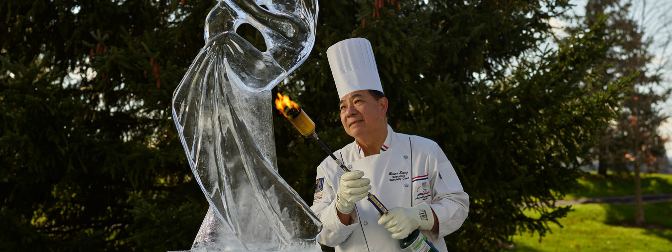 chef using fire to make ice sculpture