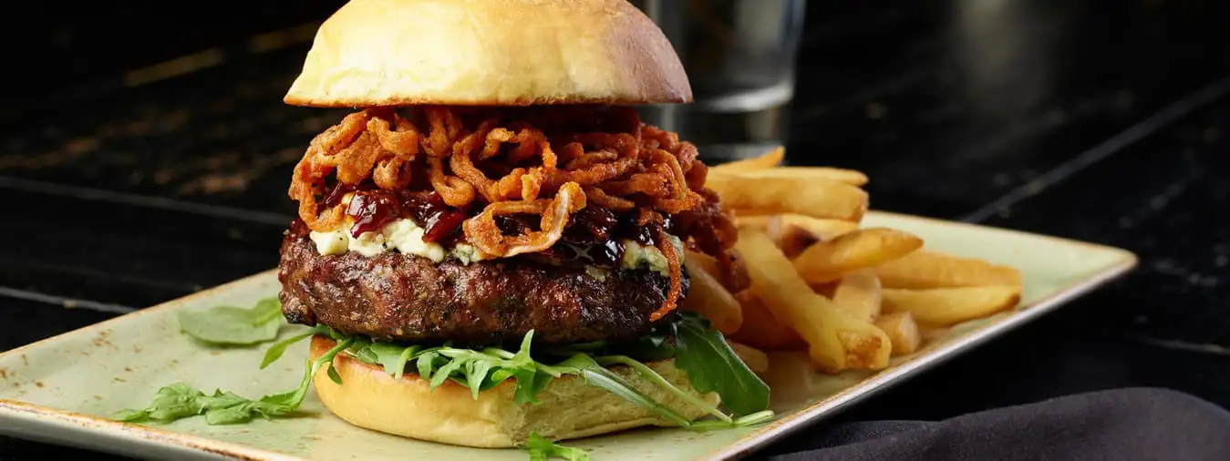 Burger with Caramelized Onions, lettuce, and Russet Fries