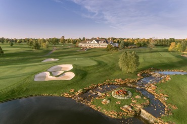 Panoramic view of Atunyote and Clubhouse with streams falling in to pond in evening sunlight