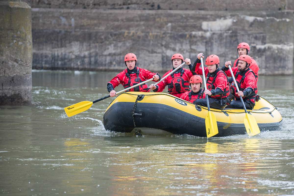 men rowing in inflatable boat