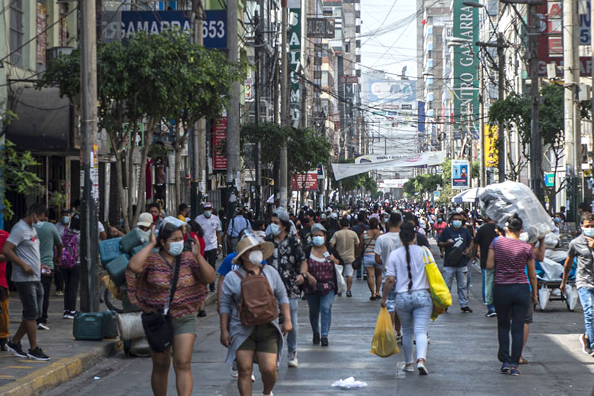 People wearing facemasks in a crowded street.