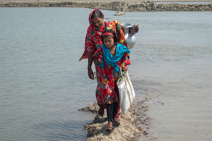 mother and daughter wading in water