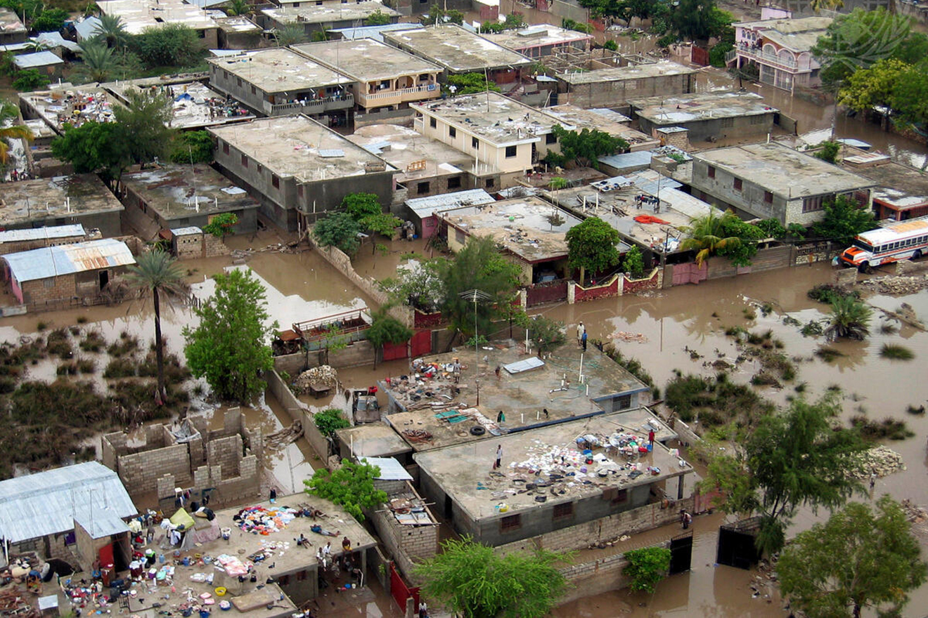 Aerial view of houses and streets affected by a flood.