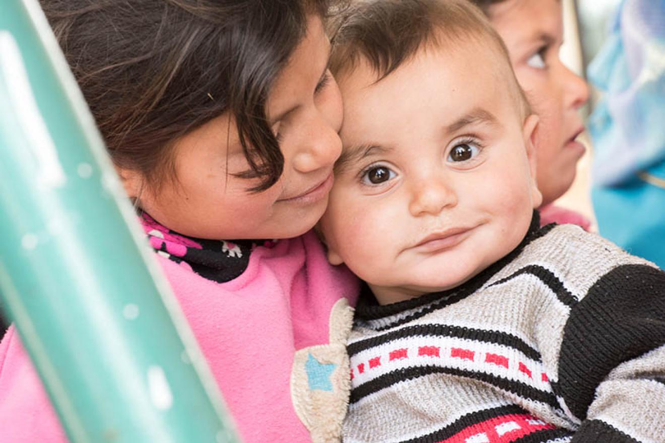 young children smiling at camera