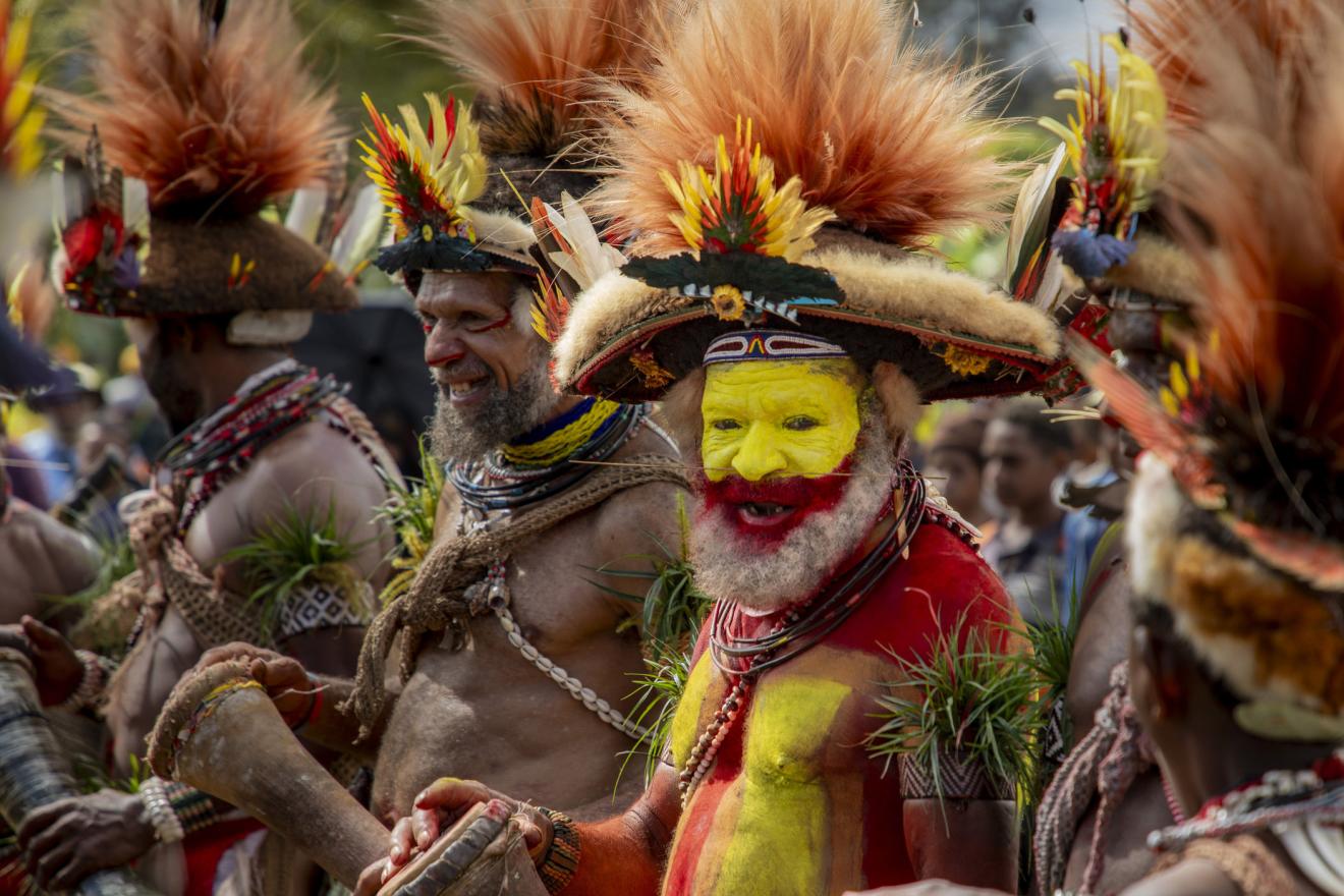 men in traditional attire and face paint