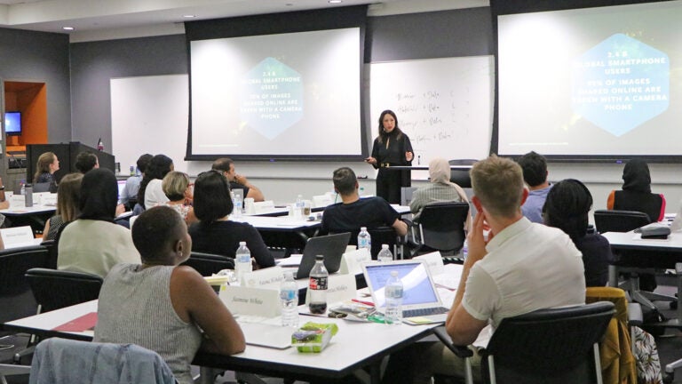 A visiting instructor lectures to a group of students during a summer class at the USC Annenberg School for Communication and Journalism.