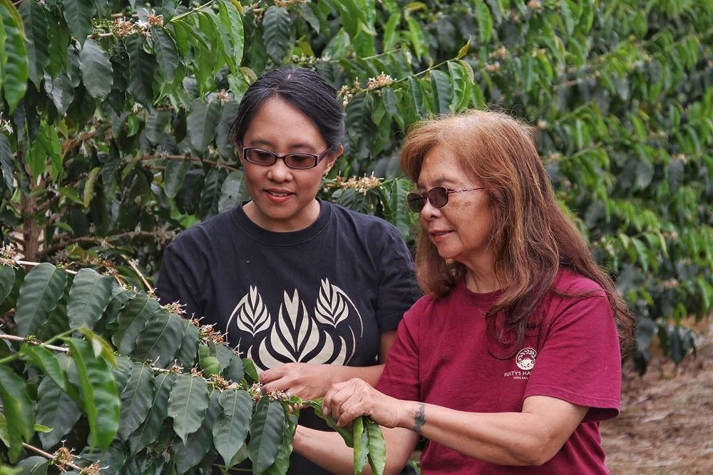 Mother and daughter near plants