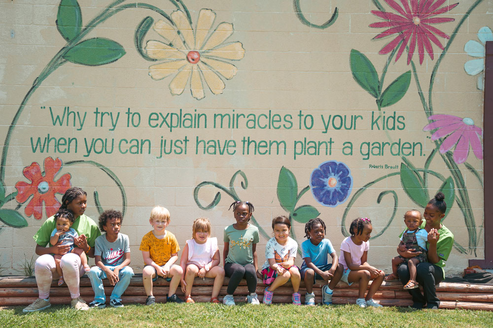 Adults with children near a wall