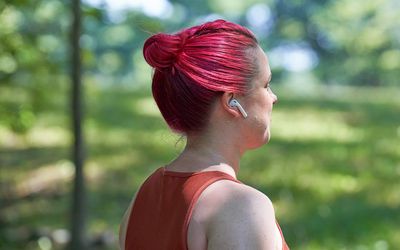 Woman walking and listening to music