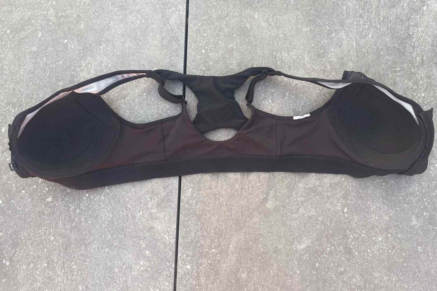 The Champion Motion Control Zip Sports Bra Wirefree on concrete