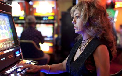 Woman using slot machine