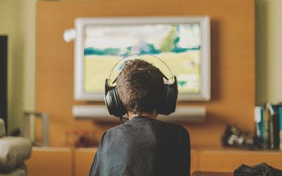 boy enjoying video game console at home