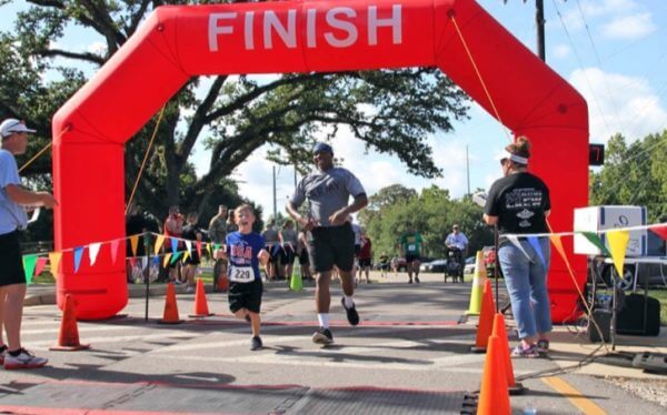 Man and boy cross finish line in a race