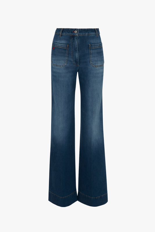 A pair of Victoria Beckham's Alina High Waisted Jean in Dark Vintage Wash, featuring blue, high-waisted, wide-leg jeans with front and back pockets, shown from the back.