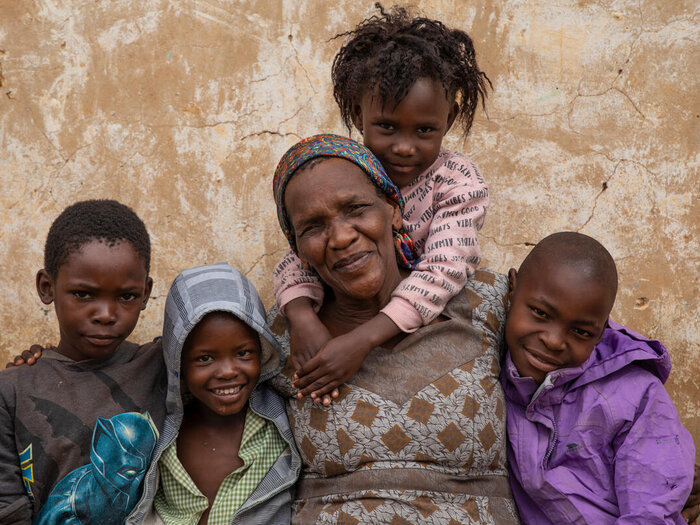 Woman facing camera with children