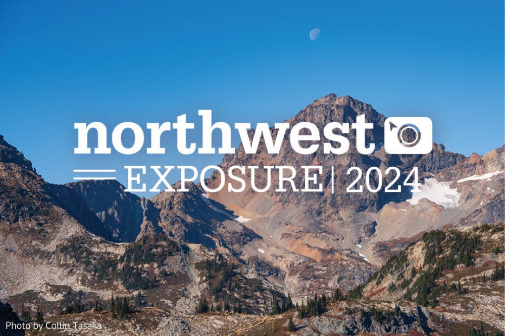 Mountains with moon above and blue skies. Northwest Exposure Photo contest logo in center.